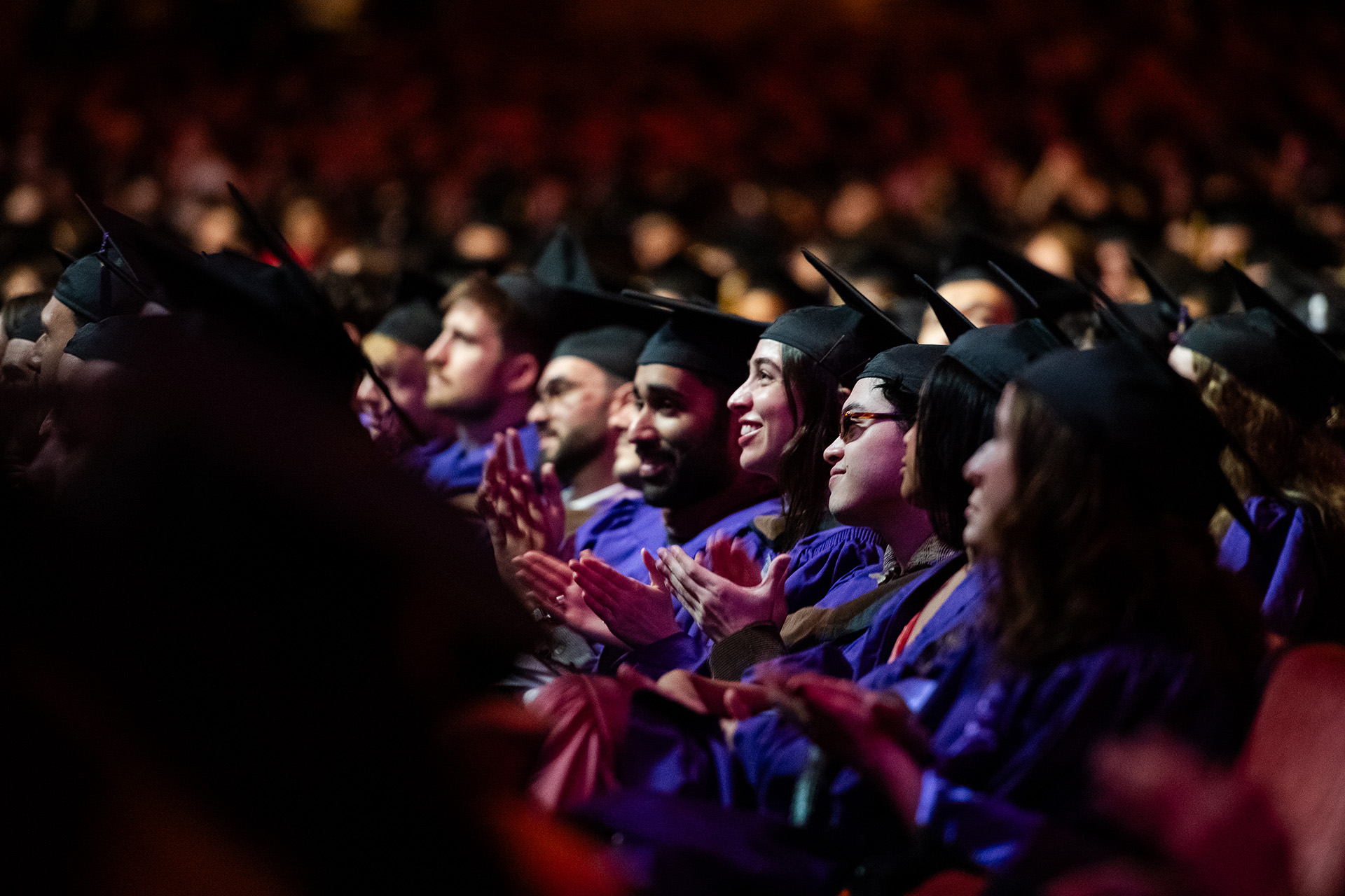 Students in Purple Gowns Clapping