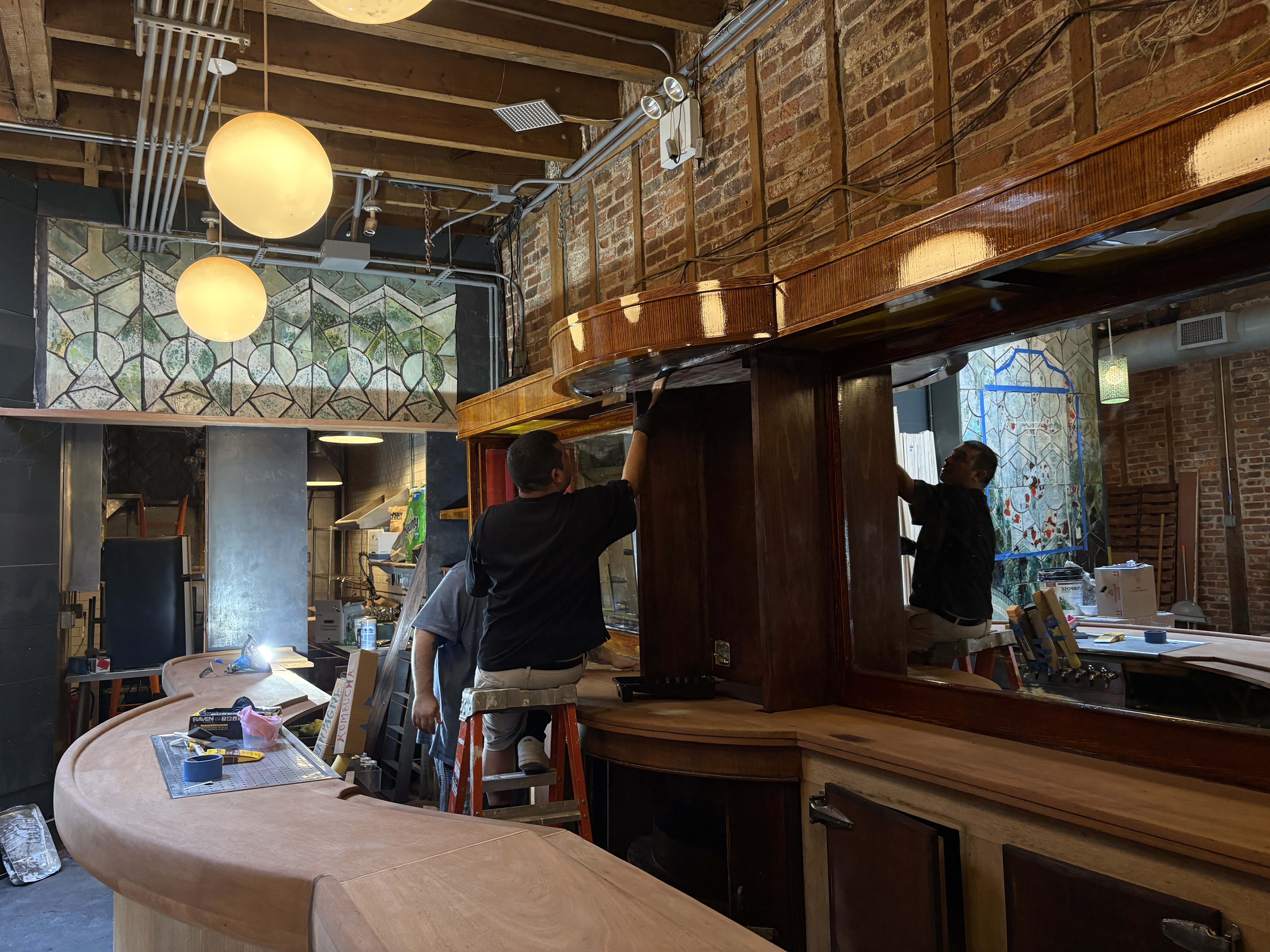 Staff staining the bar inside the theater