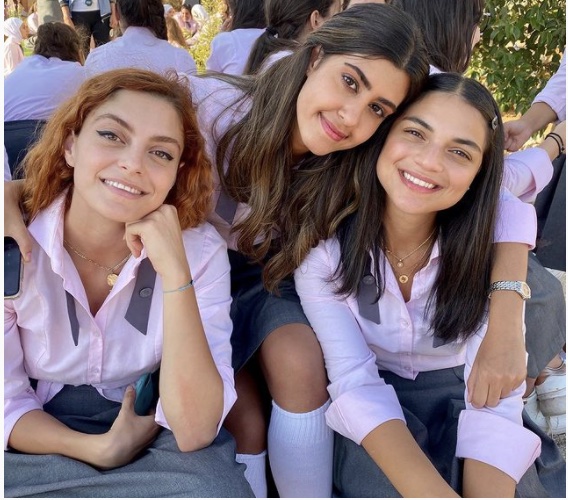 A picture of actors on the set of "AIRawabi School for Girls" in school uniforms.