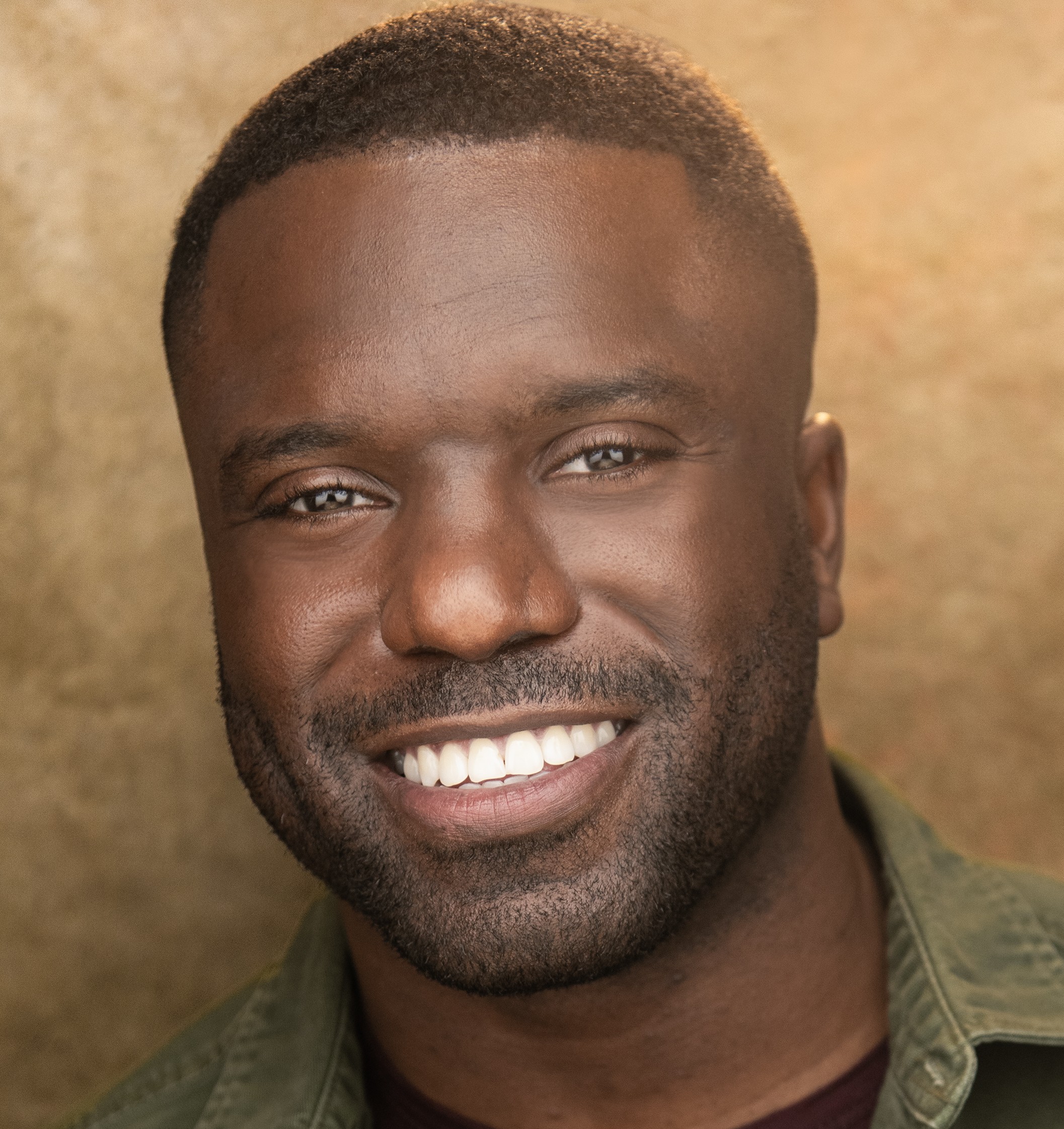 Davon Williams headshot in green shirt