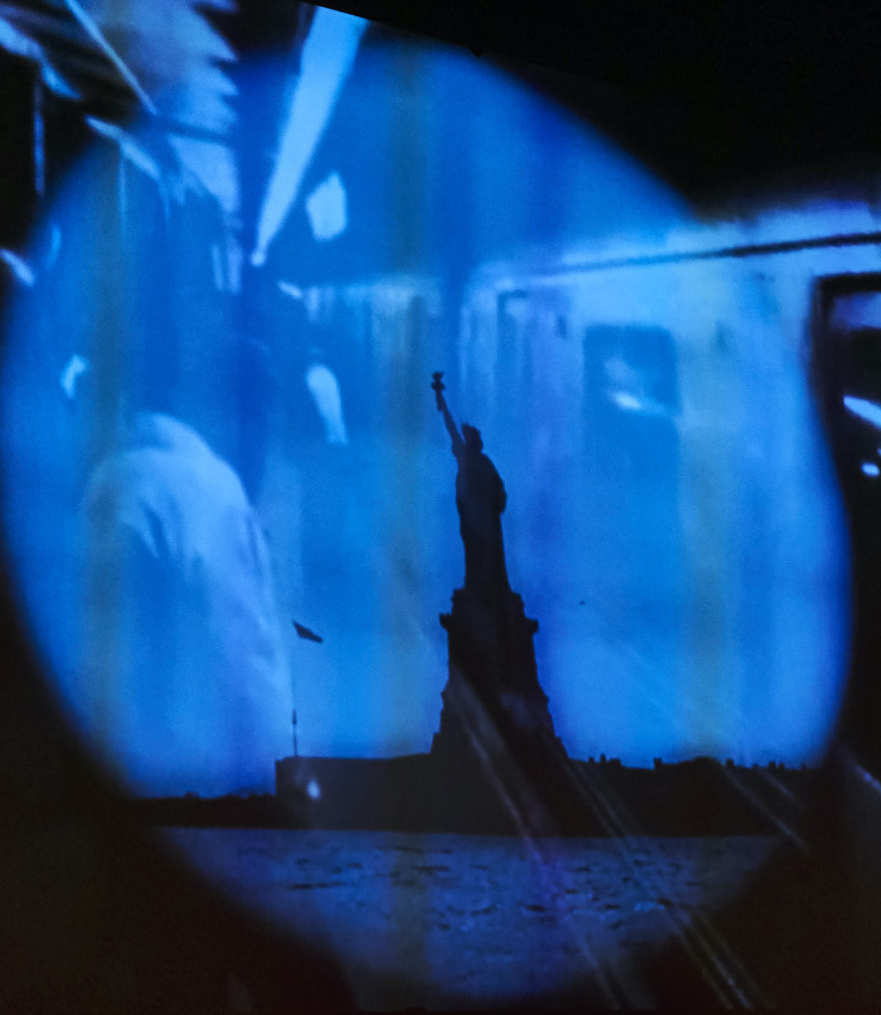 blue projection with statue of liberty shadow 