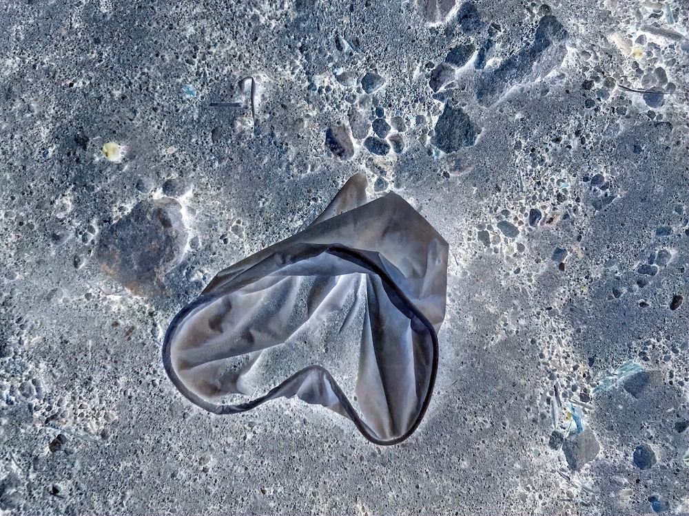 A stylized image of a plastic glove on rock