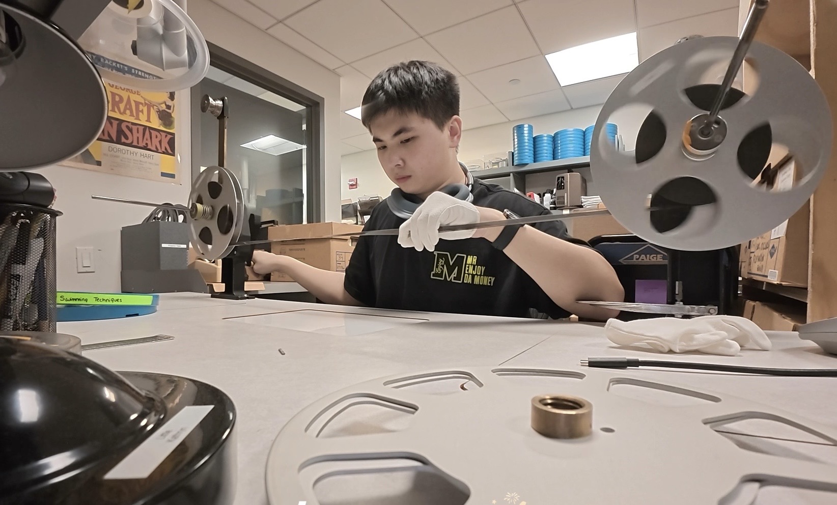 person inspecting film 