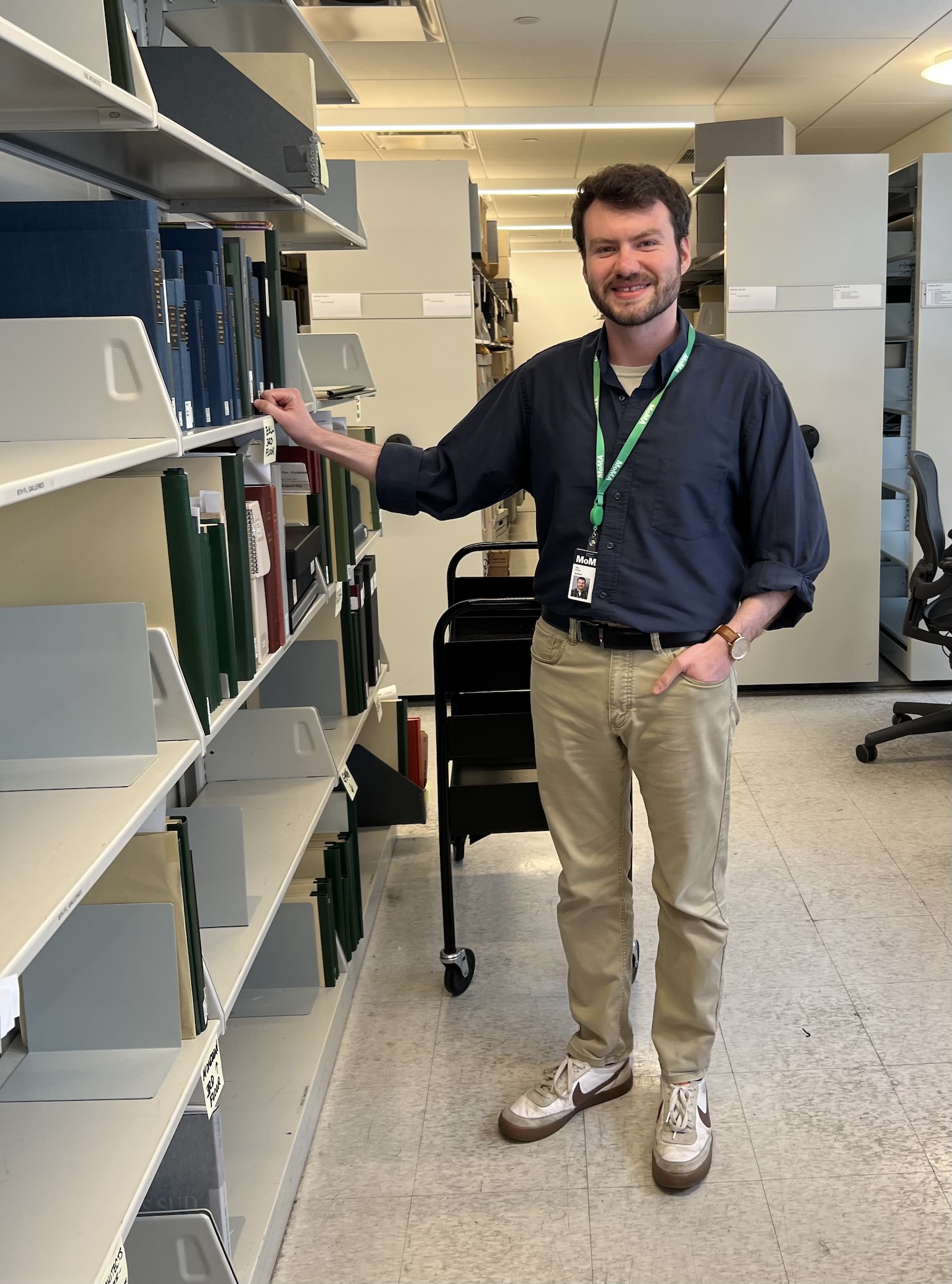 person standing at library stack