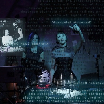 Two people with text and images projected onto their bodies.