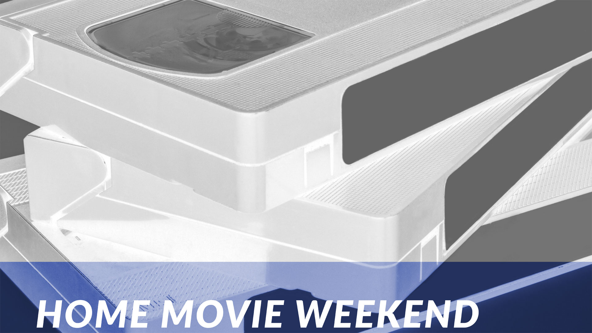 A stack of VHS tapes with text reading "Home Movie Weekend"