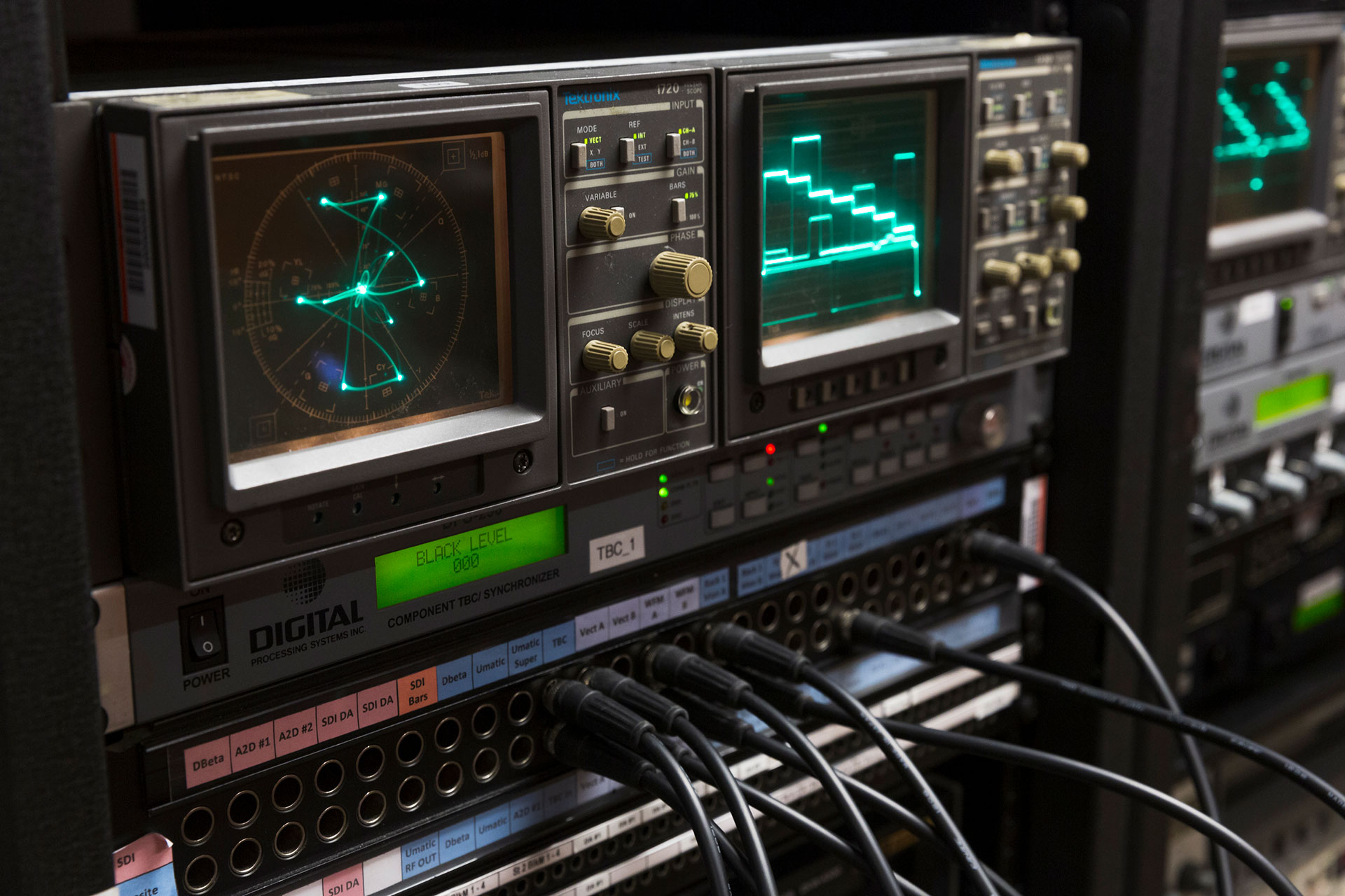 Closeup of a patch bay with monitors.