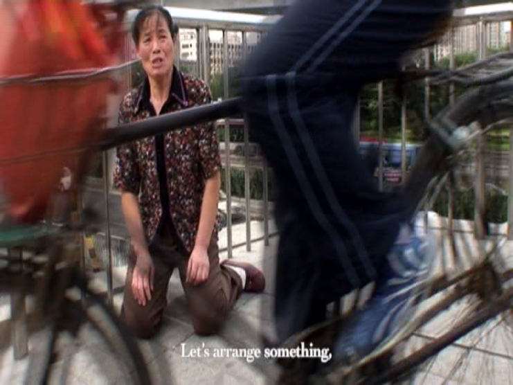 Woman kneeling while two bicyclists pass by. Subtitle reads: Let's arrange something.