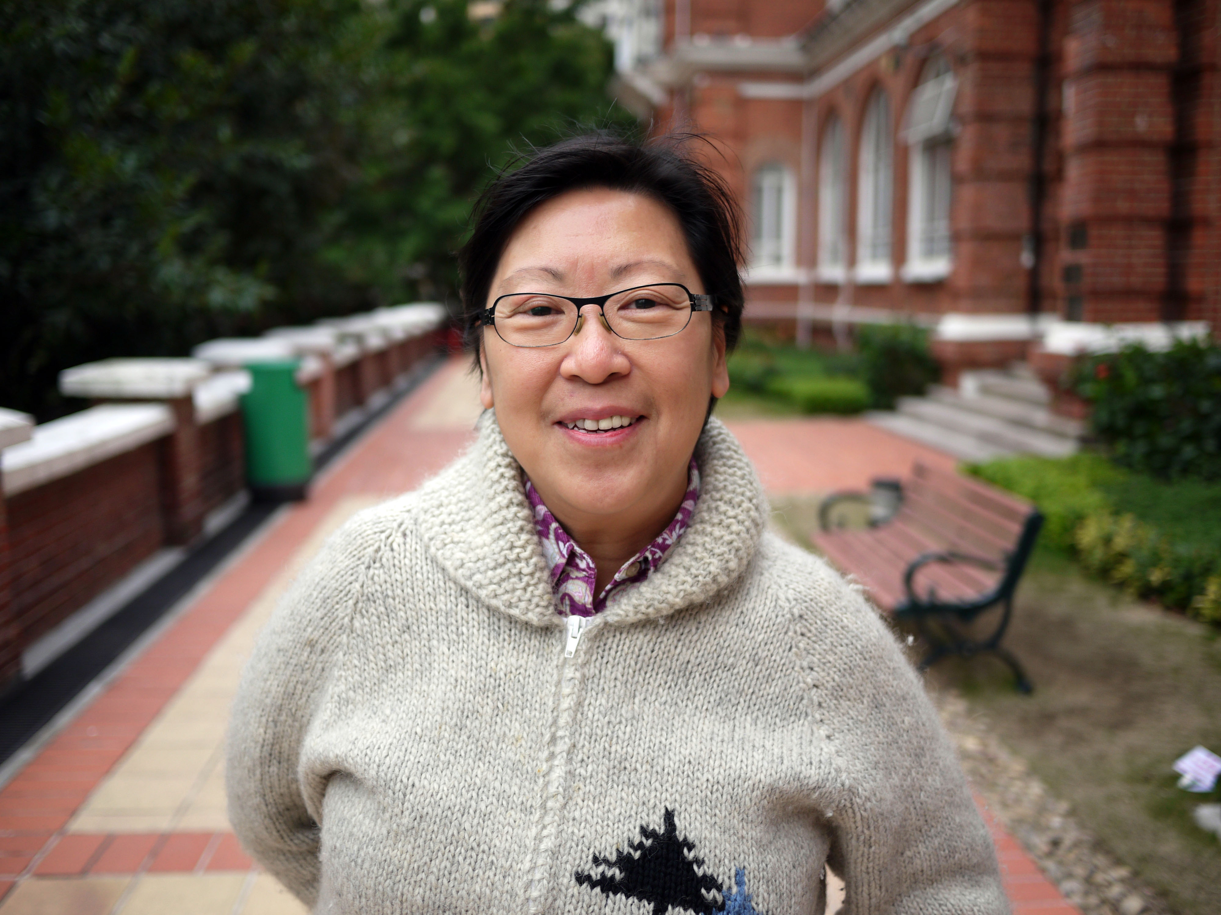 Woman with short hair and eyeglasses smiling