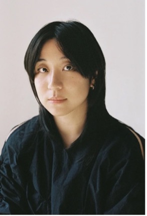 Woman with medium length hair wearing a dark shirt.