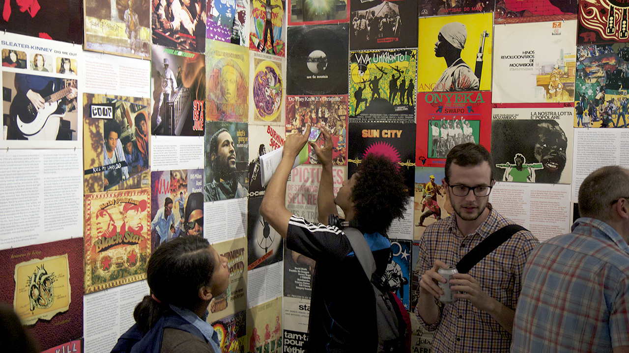 Inside Interference Archive: visitors looking at collection of flyers.