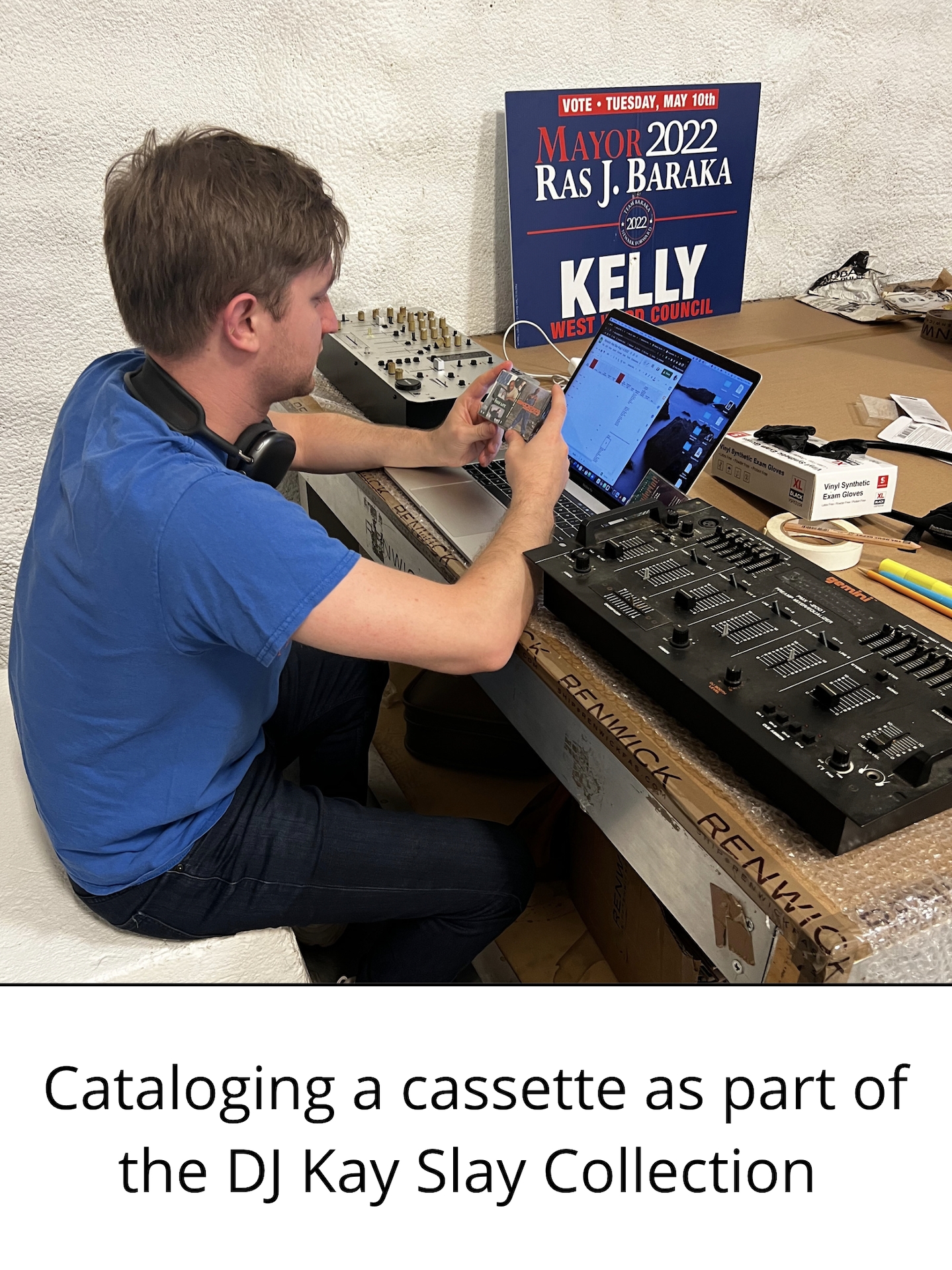 a figure types at a laptop. Text below image reads "cataloging a cassette as part of the DJ Kay Slay collection."