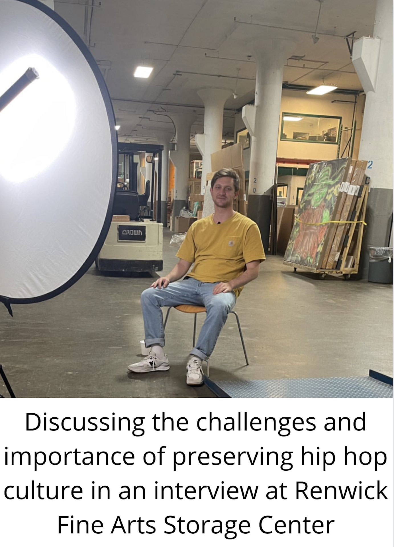 a figure is seated in a chair in the middle of a room facing the camera. The text below the image reads: "Discussing the challenges and importance of preserving hip hop culture in an interview at the Renwick Fine Arts Storage Center."