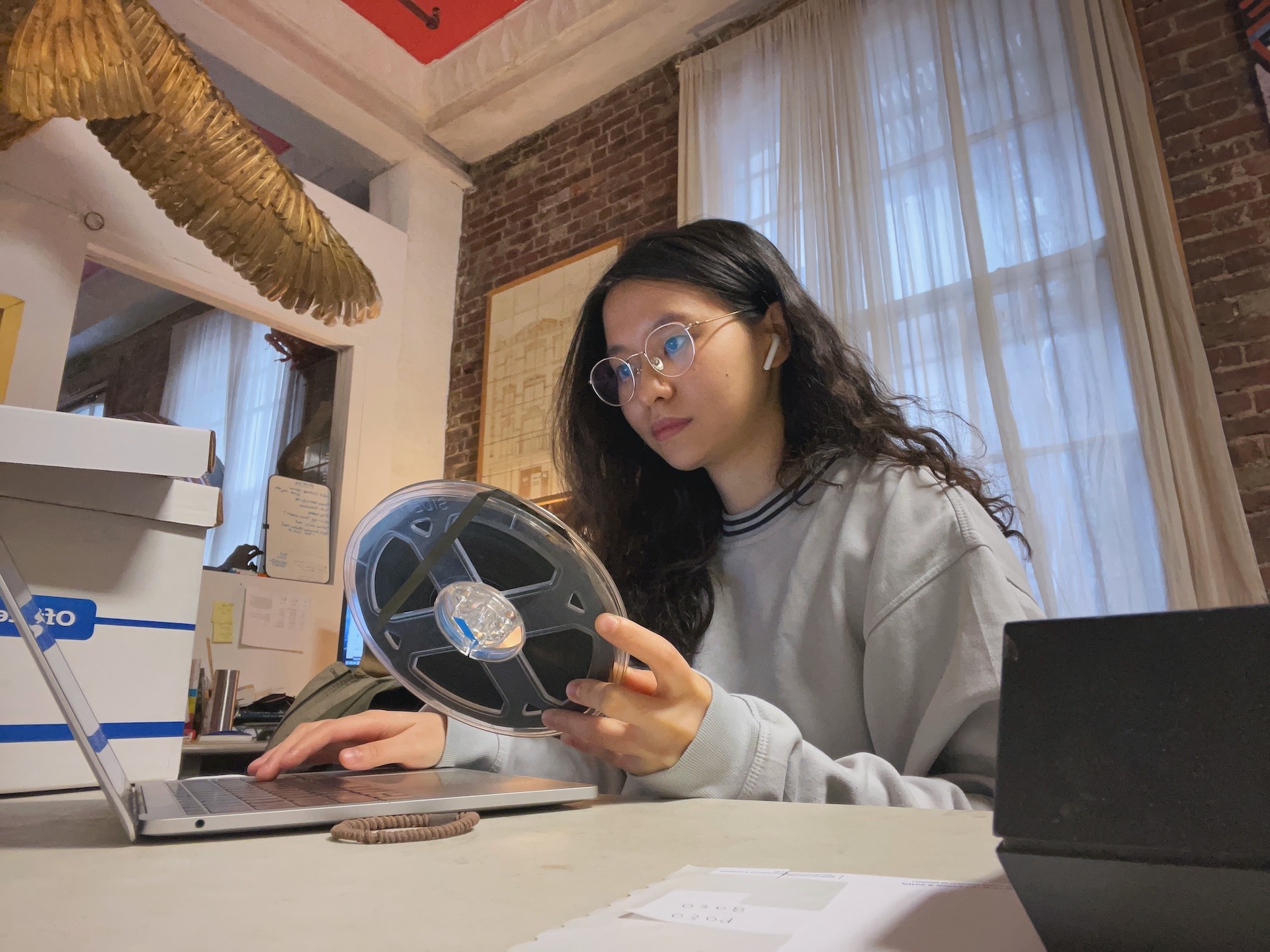 person inspecting a reel of film