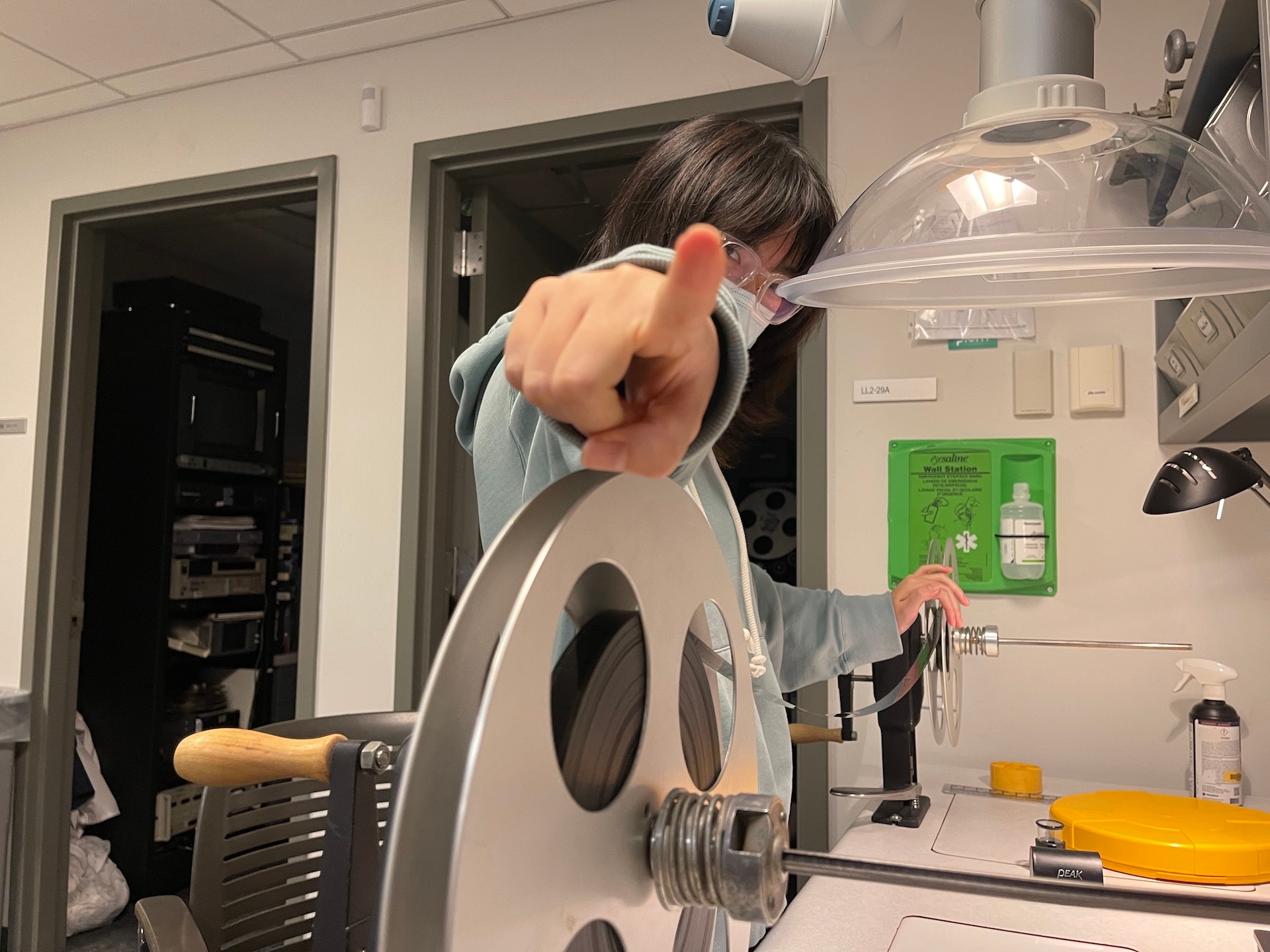 person inspecting a reel of film