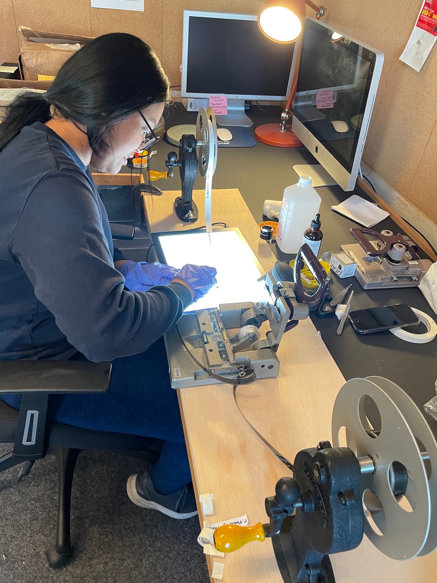 person inspecting a reel of film