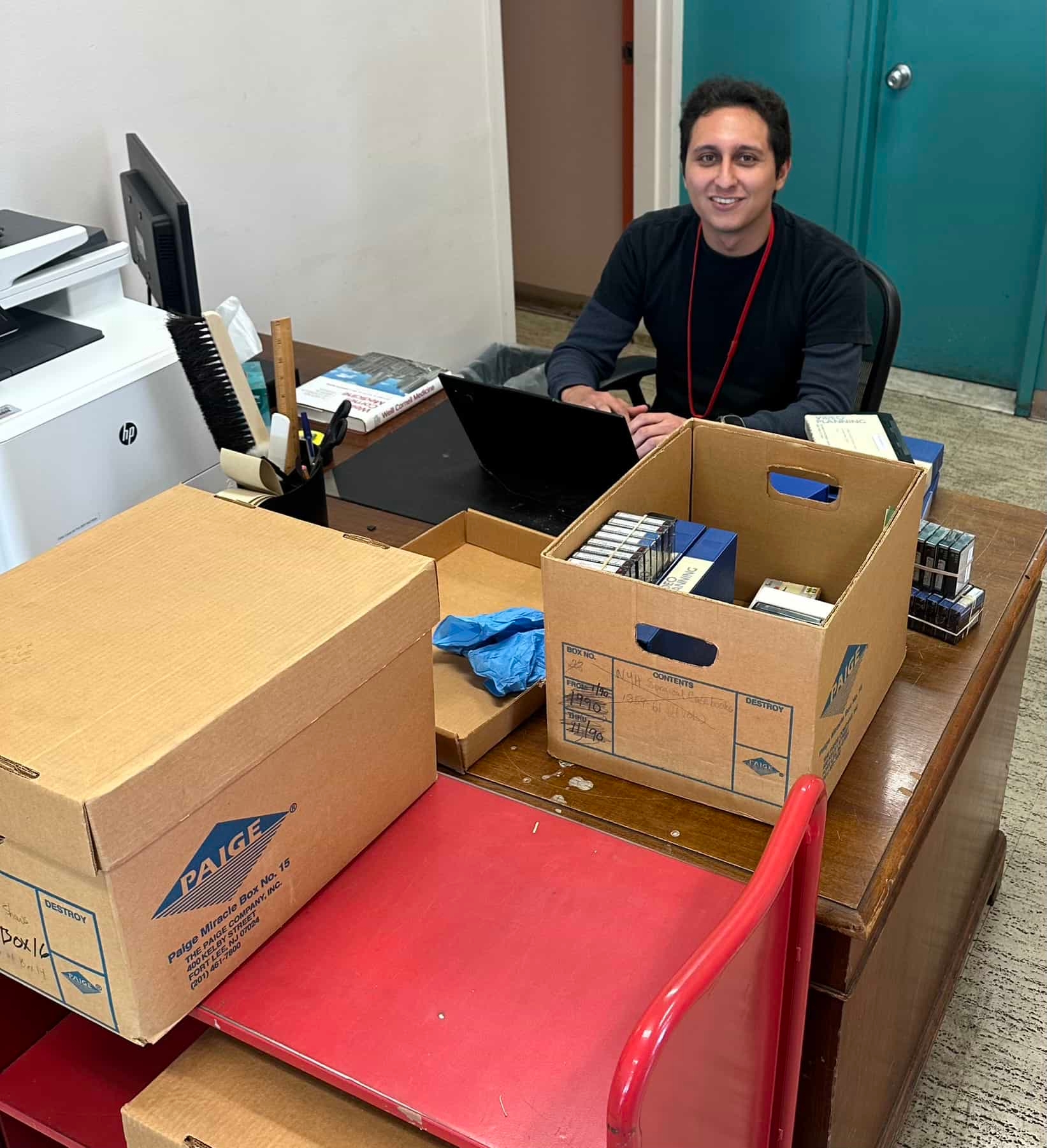 person sitting in front of boxes