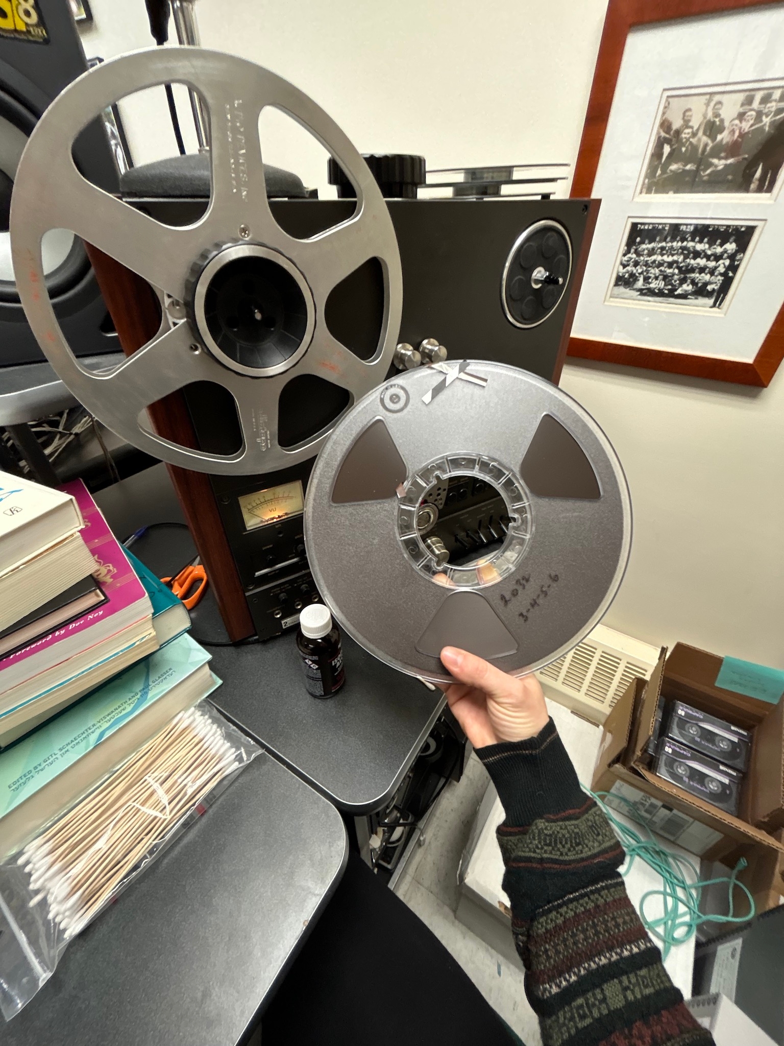 hand holding up reel of audiotape