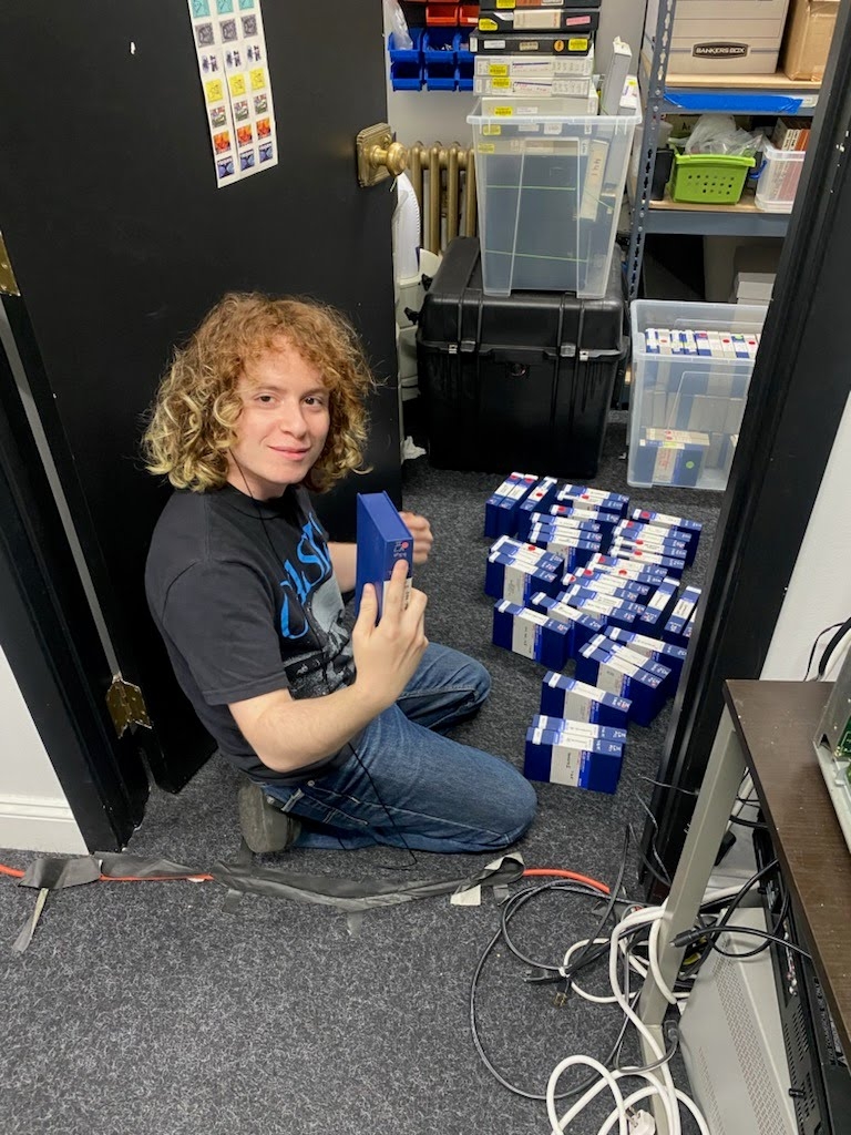 person kneeling in a doorway with tapes