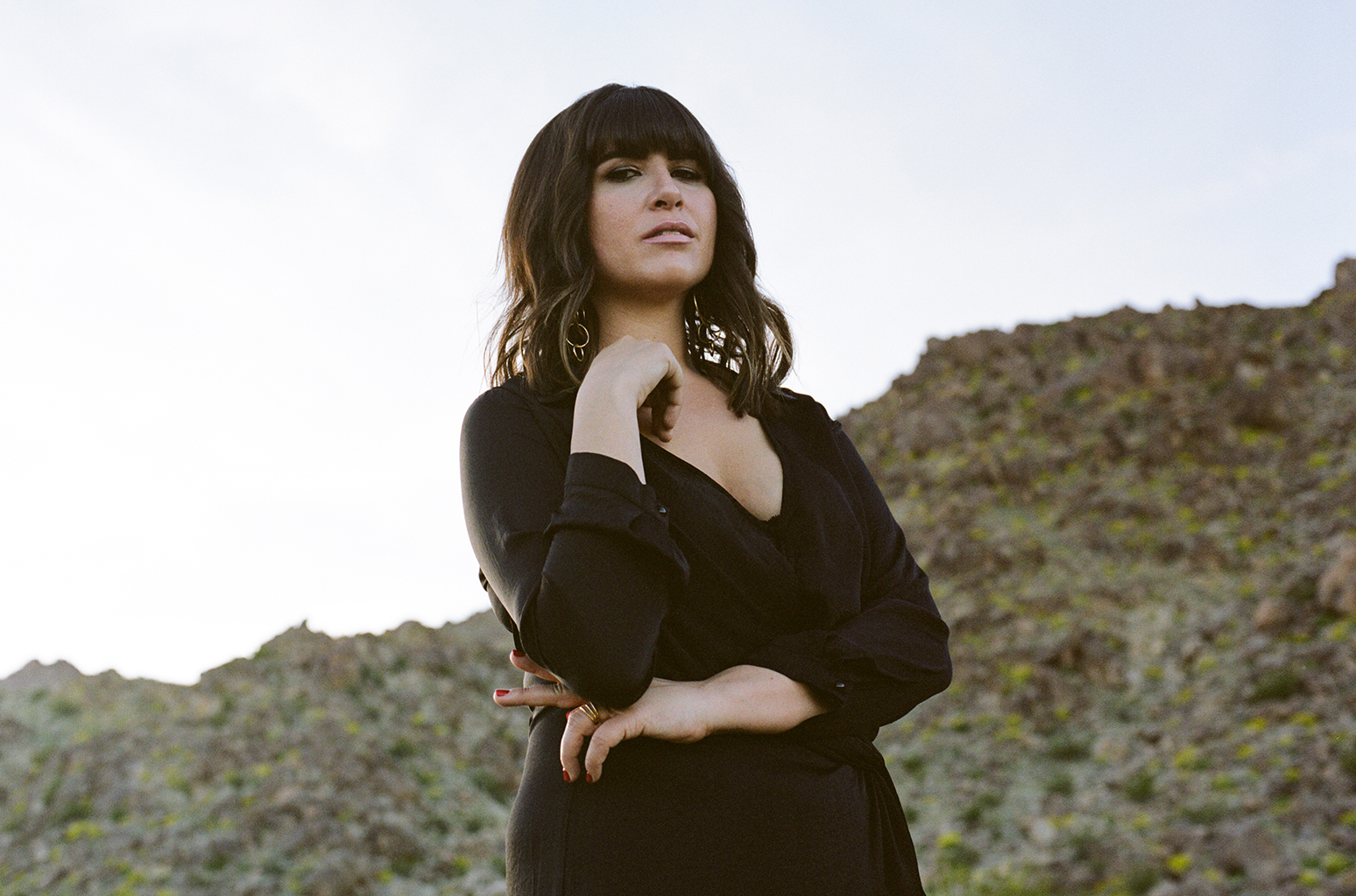 Press photo of Emily Warren in front of mountains