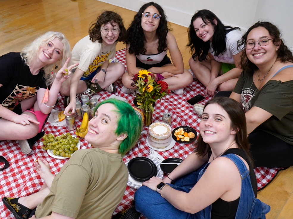 Group of students having a picnic indoors