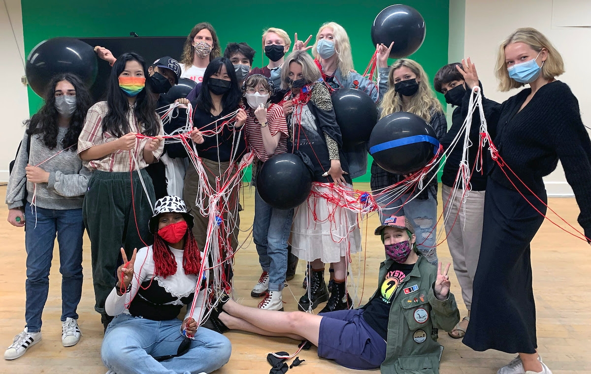 Group of students posing and covered in string