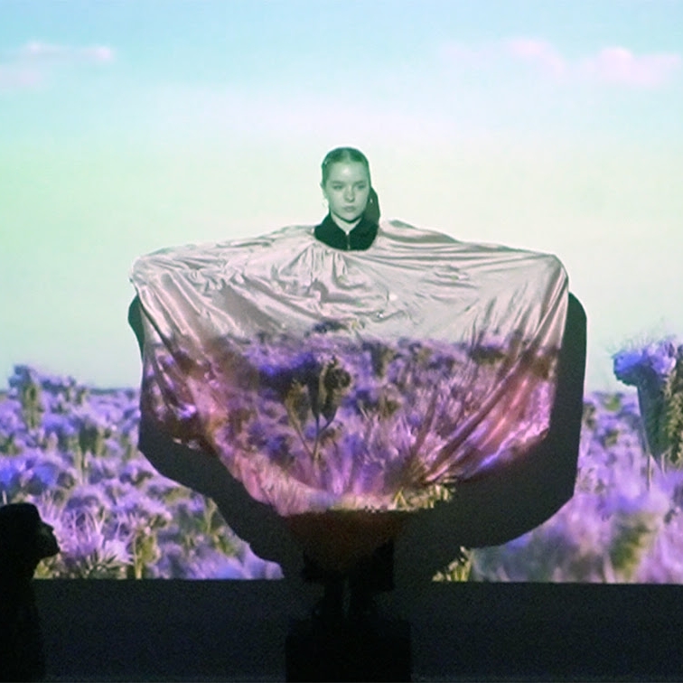 Student performing with projection for body library