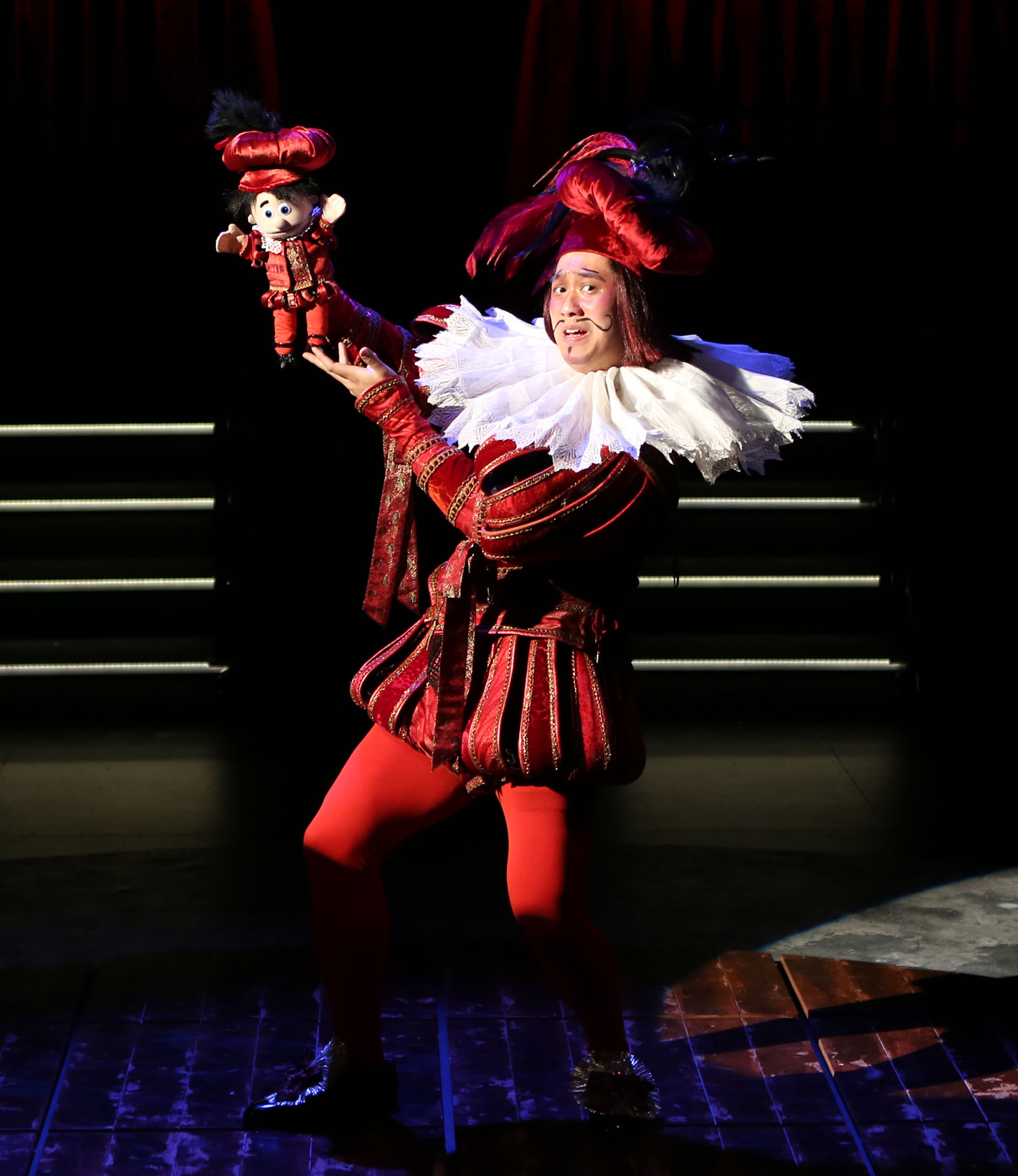 A person sitting down and a person standing up on a stage