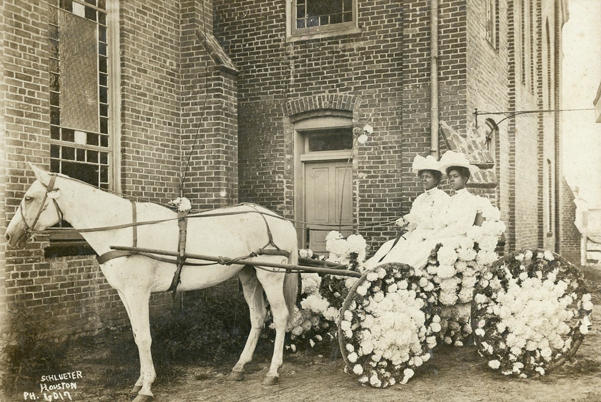 two women riding carriage in early 1900s