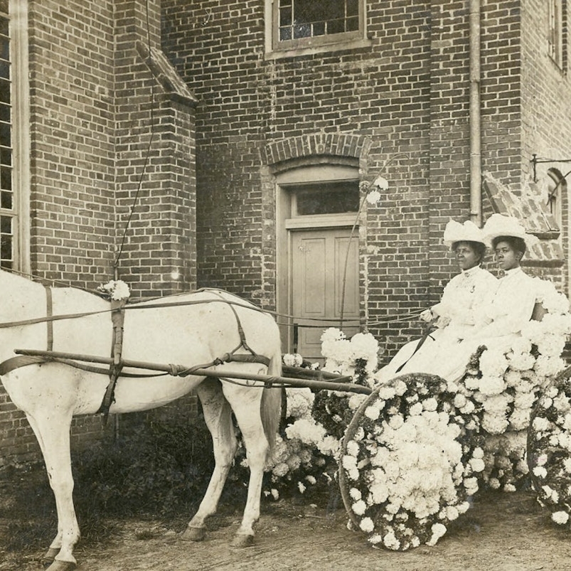 two women riding carriage in early 1900s