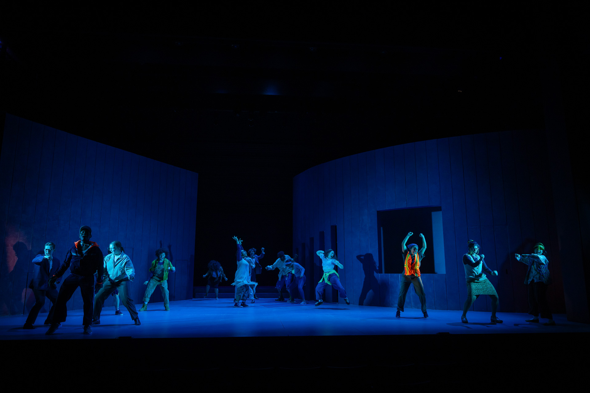 people dancing on a dimly lit stage