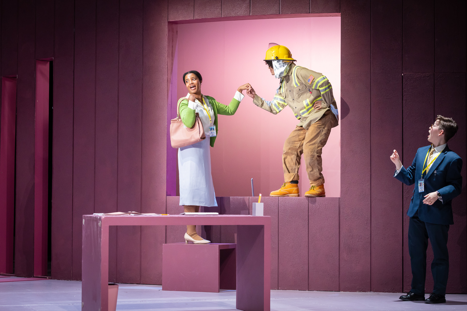 a woman and a fireman standing in a window