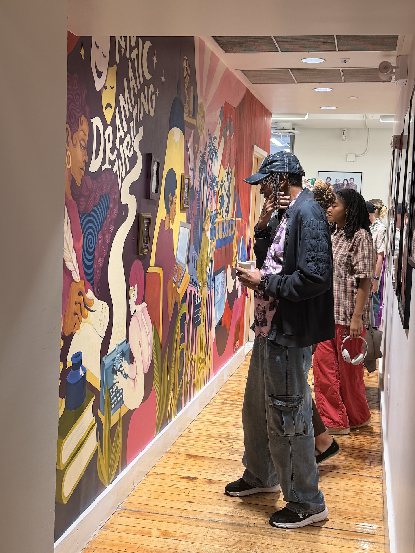 Dramatic Writing Community Members Observing Mural