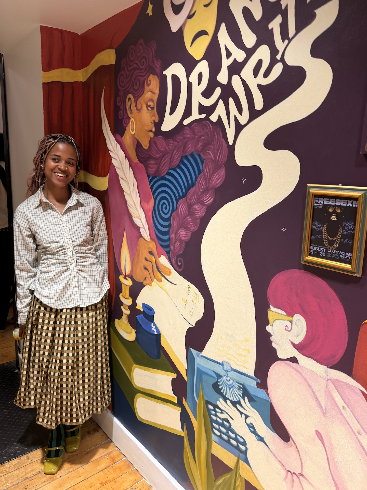Artist, Yetunde Sapp, standing next to mural