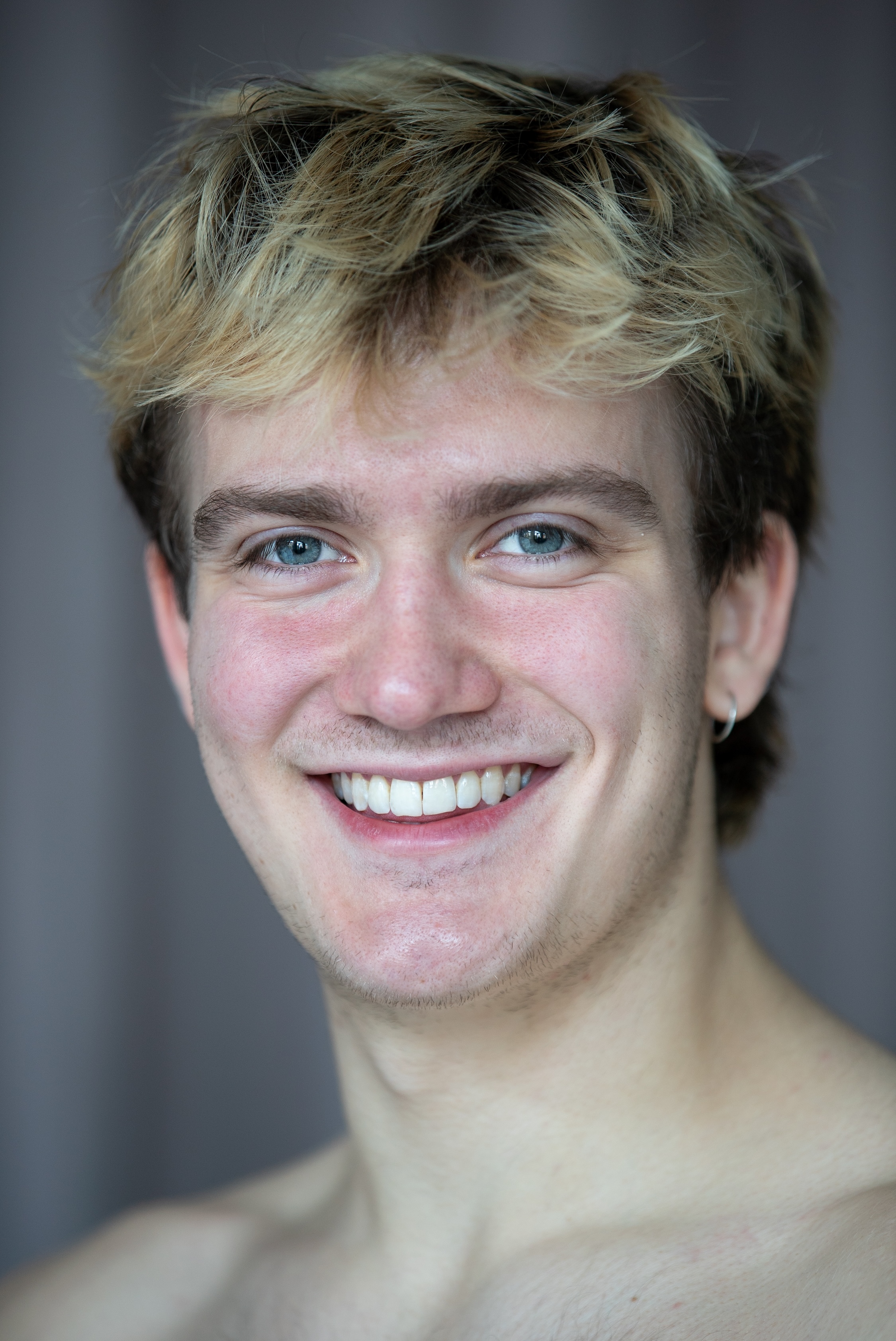 smiling student with blue eyes and short blonde hair