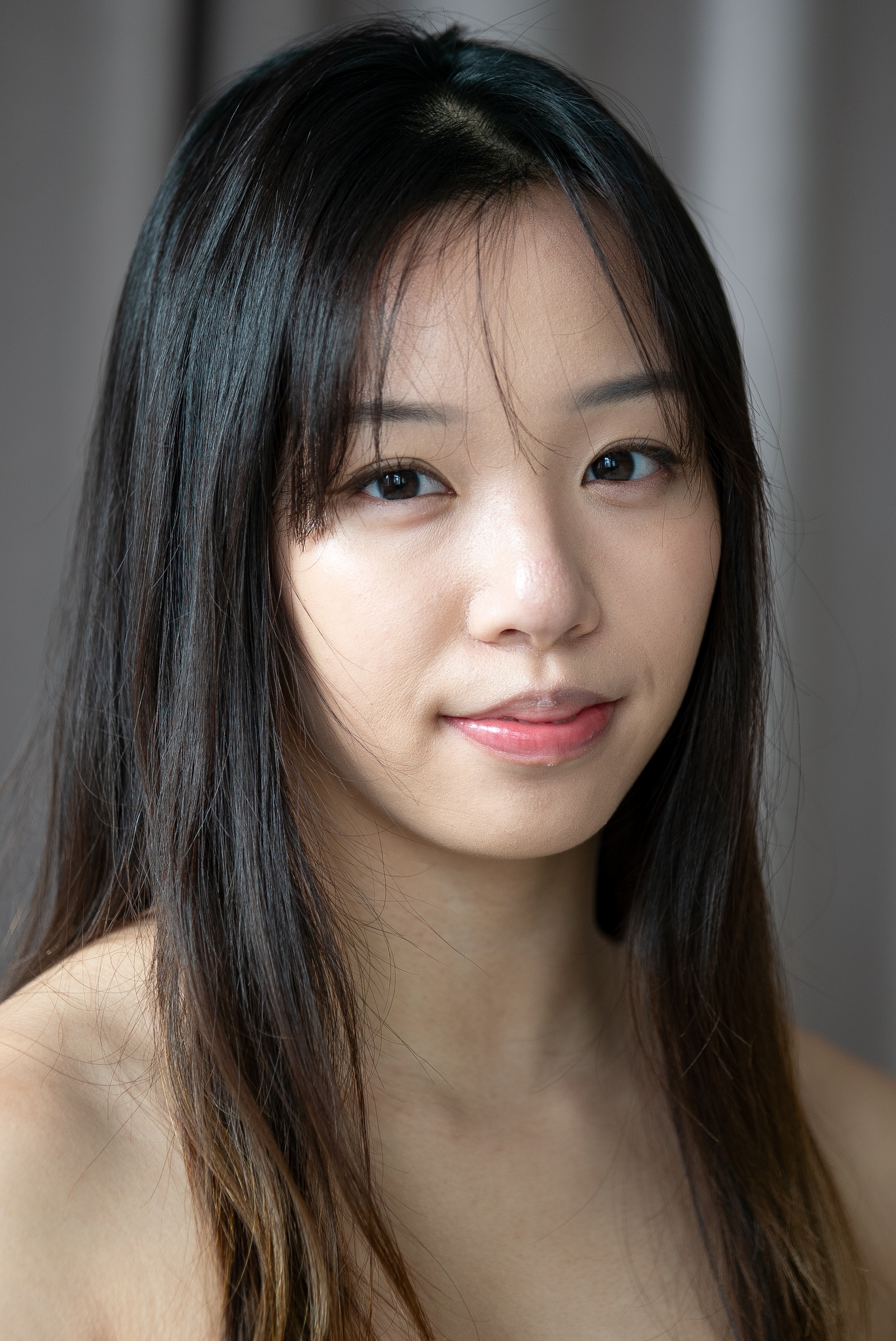 student with dark hair with bangs swept to each side. 