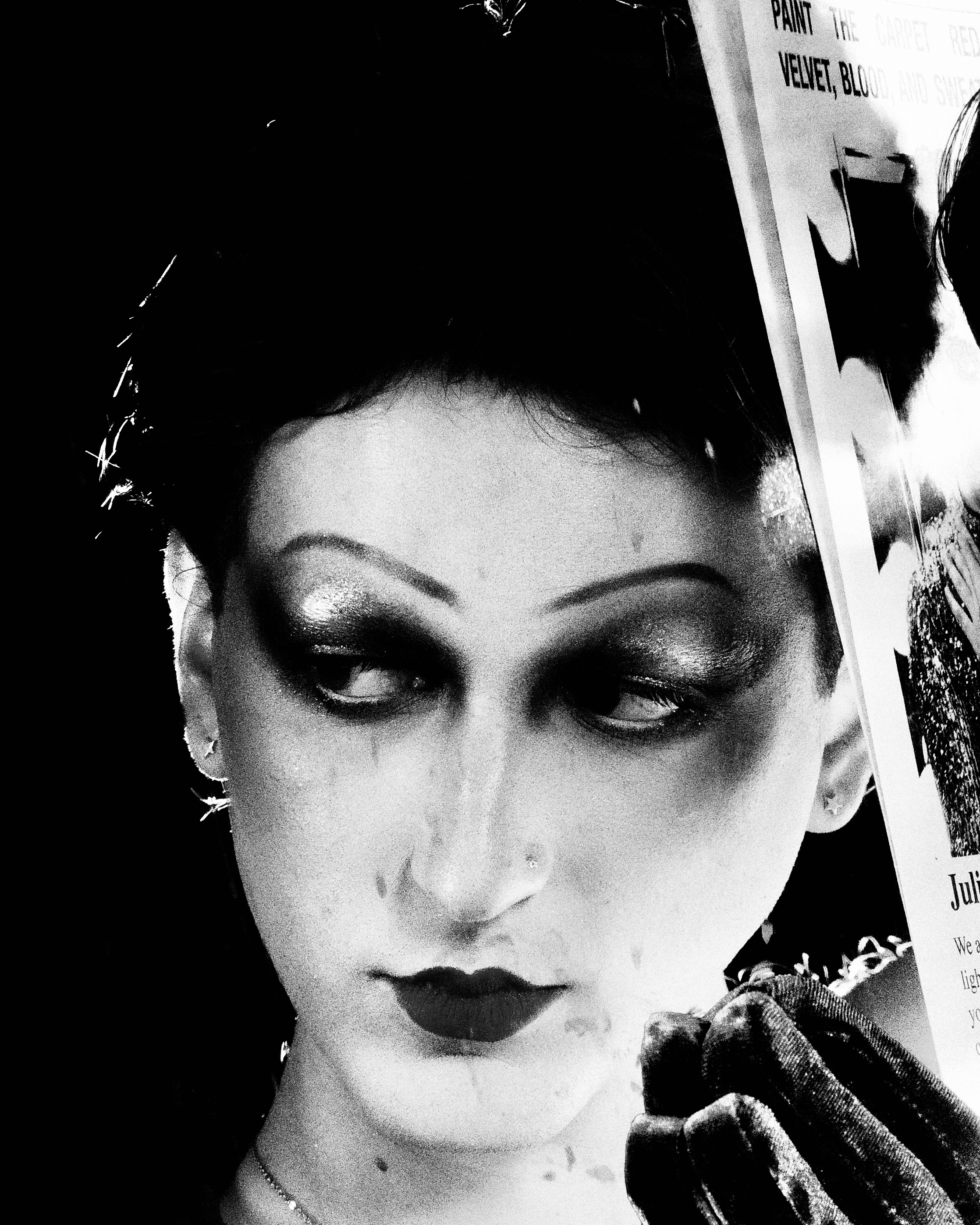 black and white photo of student with dark makeup and pleasant look in the eyes