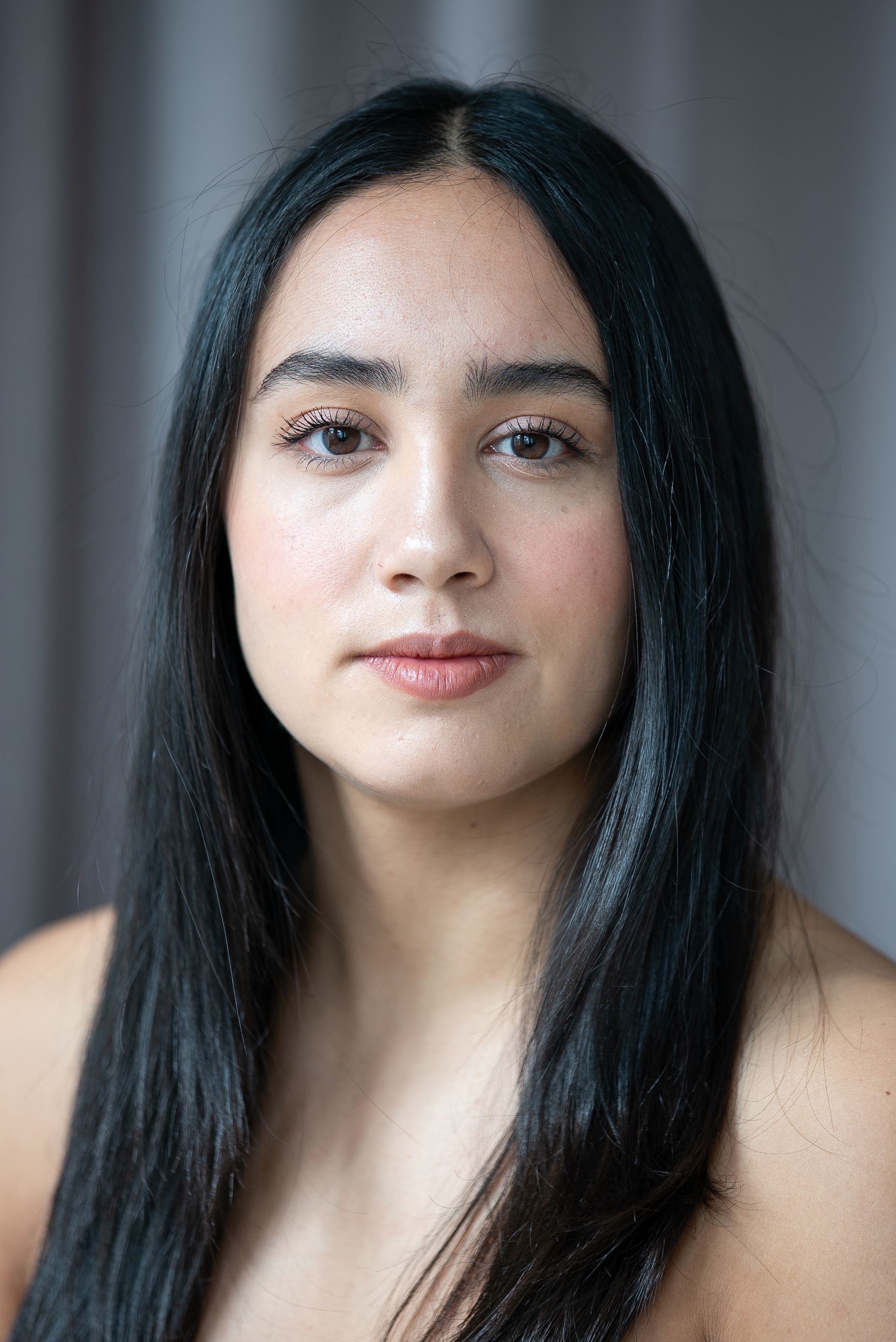 student with dark eyes and dark hair that goes past the shoulders