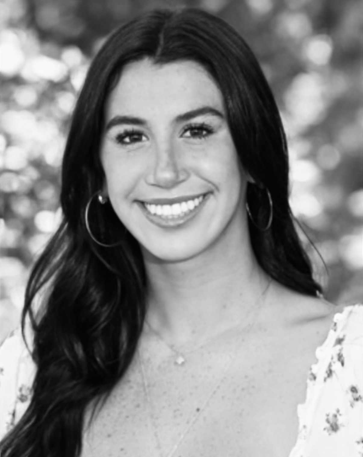 black and white photo of smiling student with long brown hair