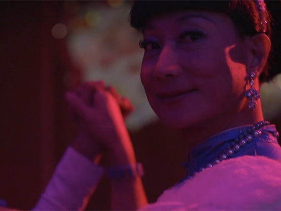 Film Still from Blooming Night. Close up of woman's face while she is dancing. 