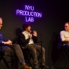Filmmaker Mica Levi sits in conversation with Grad Film Chair Andrew Okpeaha MacLean and one other person in front of a neon sign that reads "NYU Production Lab"