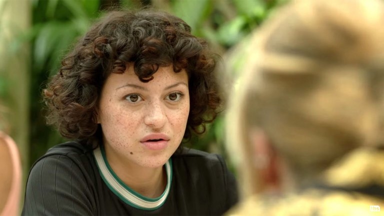 Actress Alia Shawkat facing a woman whose back is to the camera.