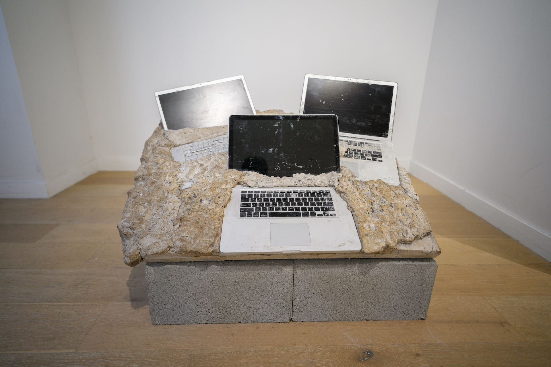 Laptops covered in concrete