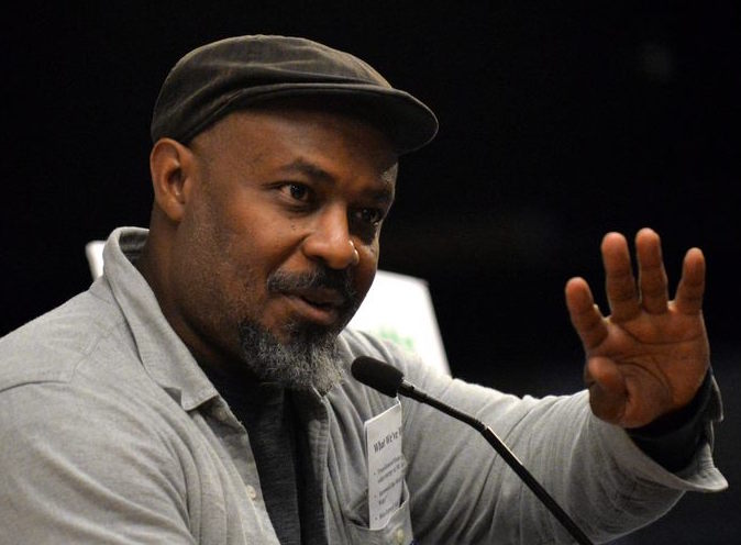  Man speaks at a podium