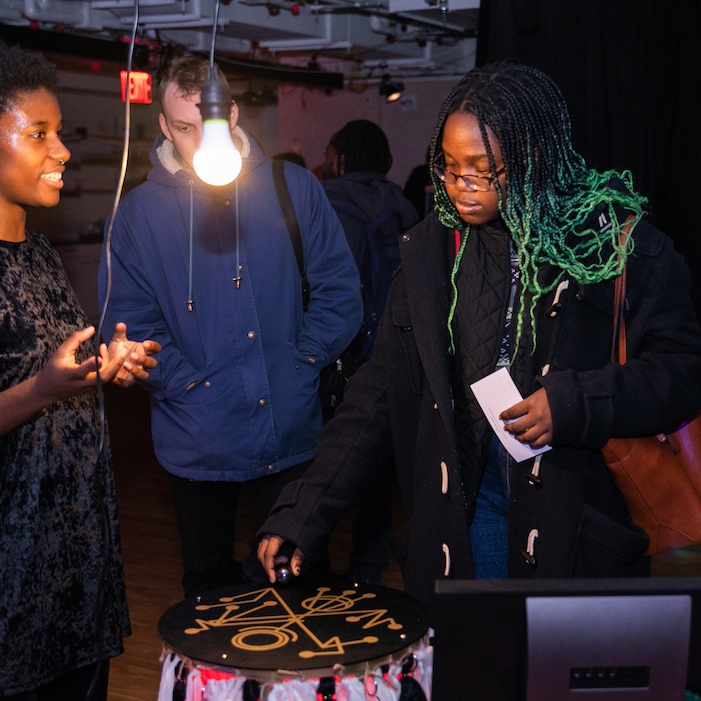 People interacting with projects at the show