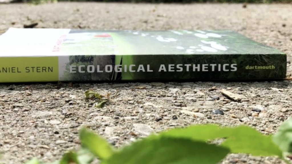 Pictures of the book Ecological Aesthetics outside in a green space
