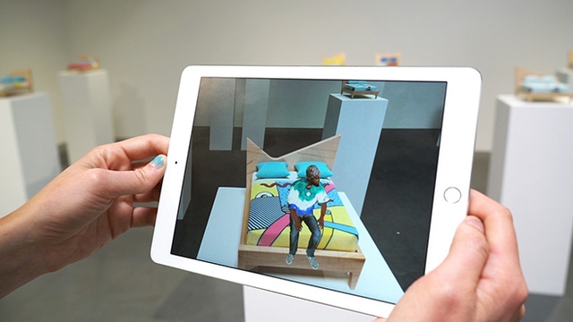 Screen showing augmented reality with live people that aren't really there