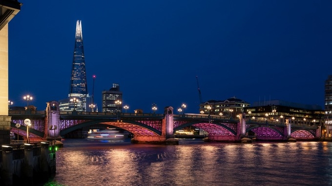 Colored lights illuminate the River Thames