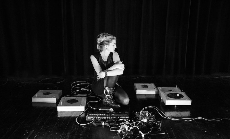 image of Lesley Flanigan surrounded by DJ equipment