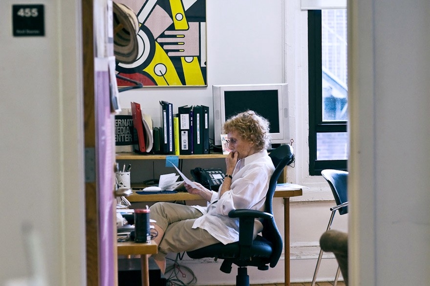 Red works at her computer in her office